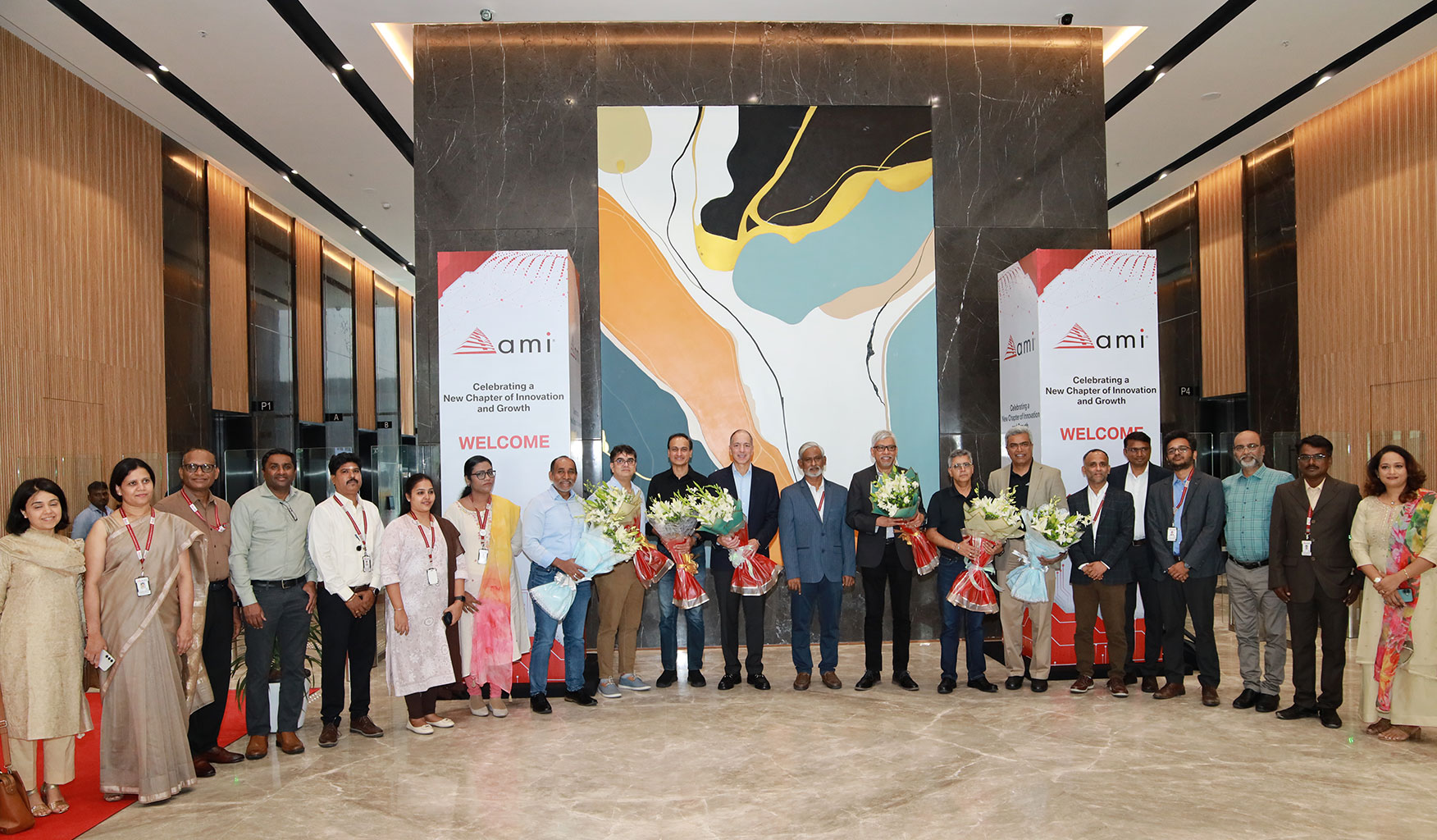 Large group posing in the lobby of the new AMI Chennai office