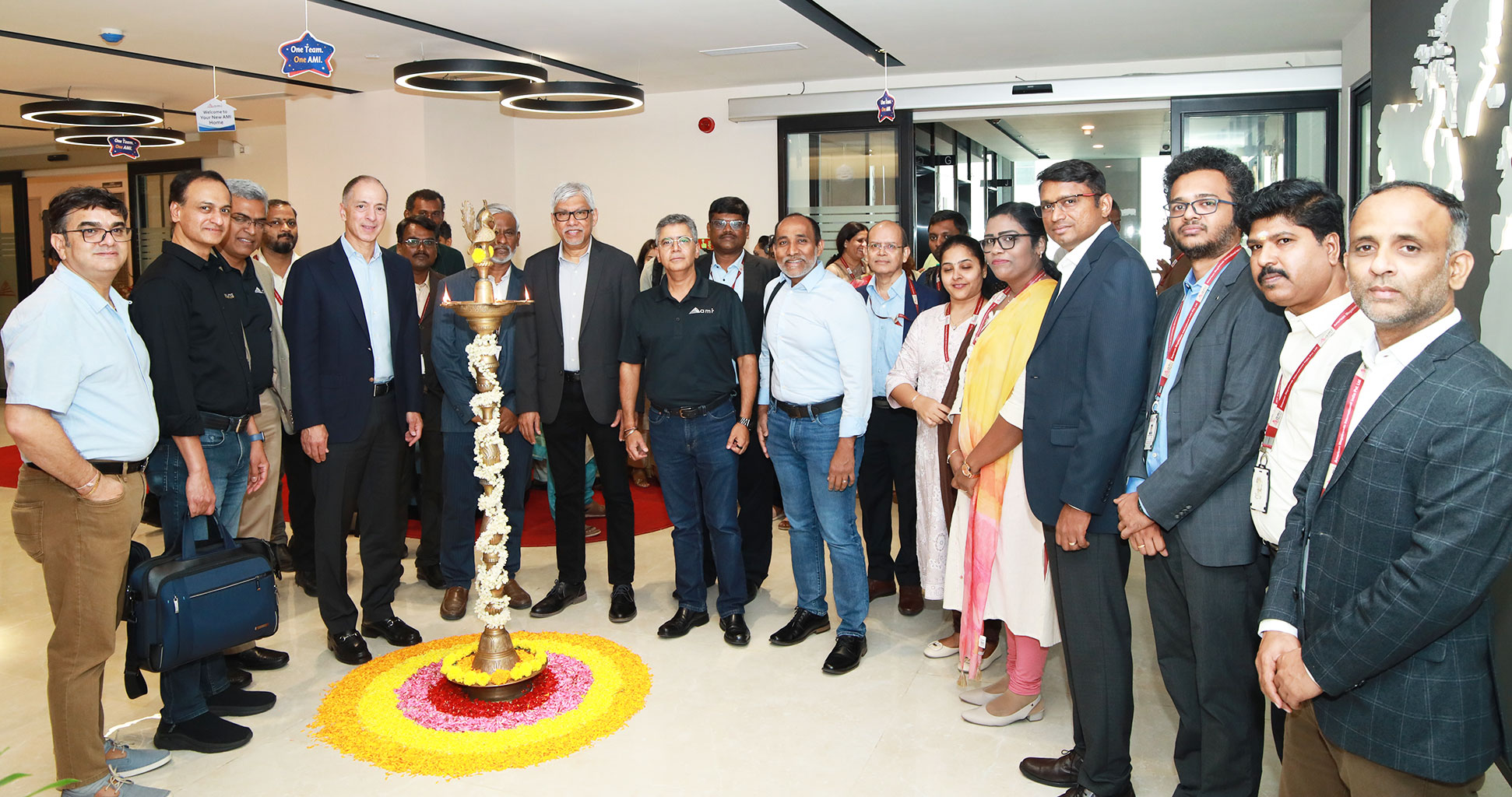 large group posing in an open hallway of the new AMI office in Chennai